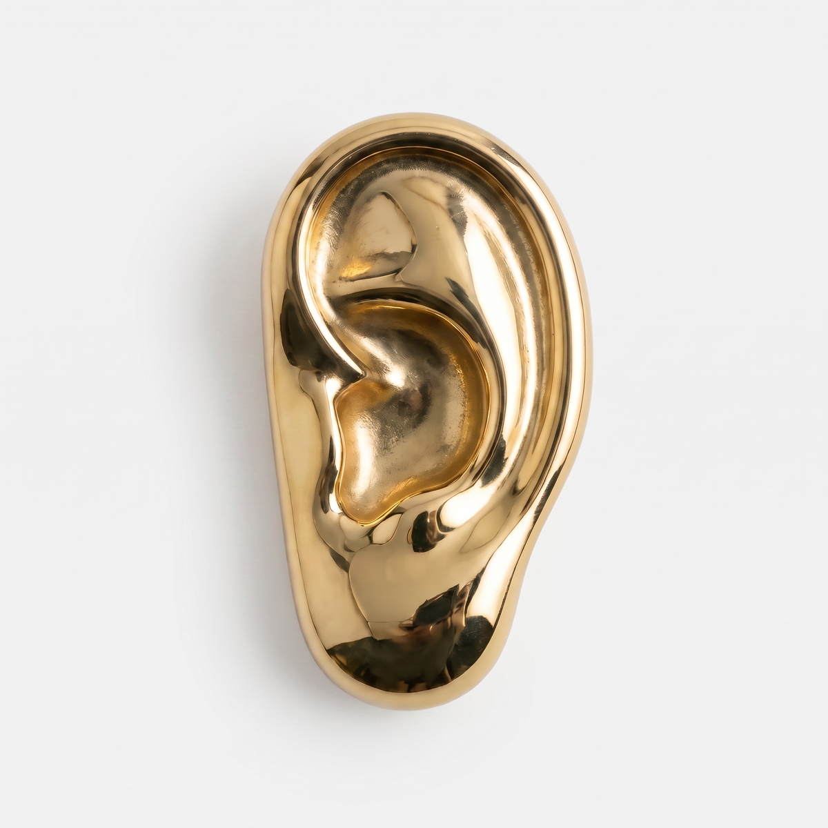 Vincent's Ear bottle opener in polished brass, styled on a table
